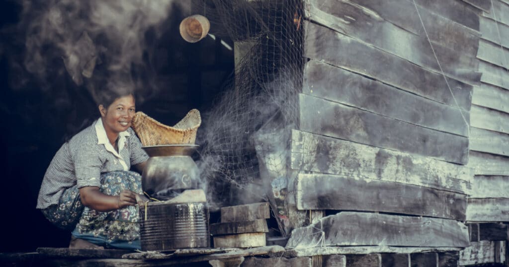 woman cooking outdoors in the village