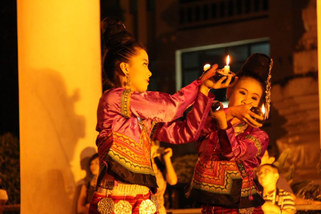 Thai ladies in traditional dress with candles