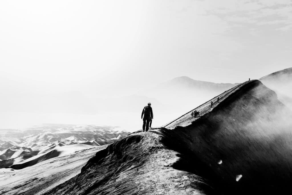 Active travel man walking on dune