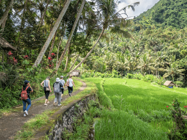 Ayu with Discova leadership team walking through the village in Manggis
