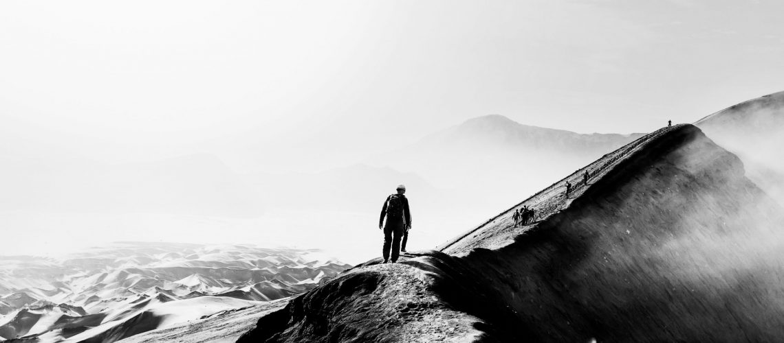 Active travel man walking on dune